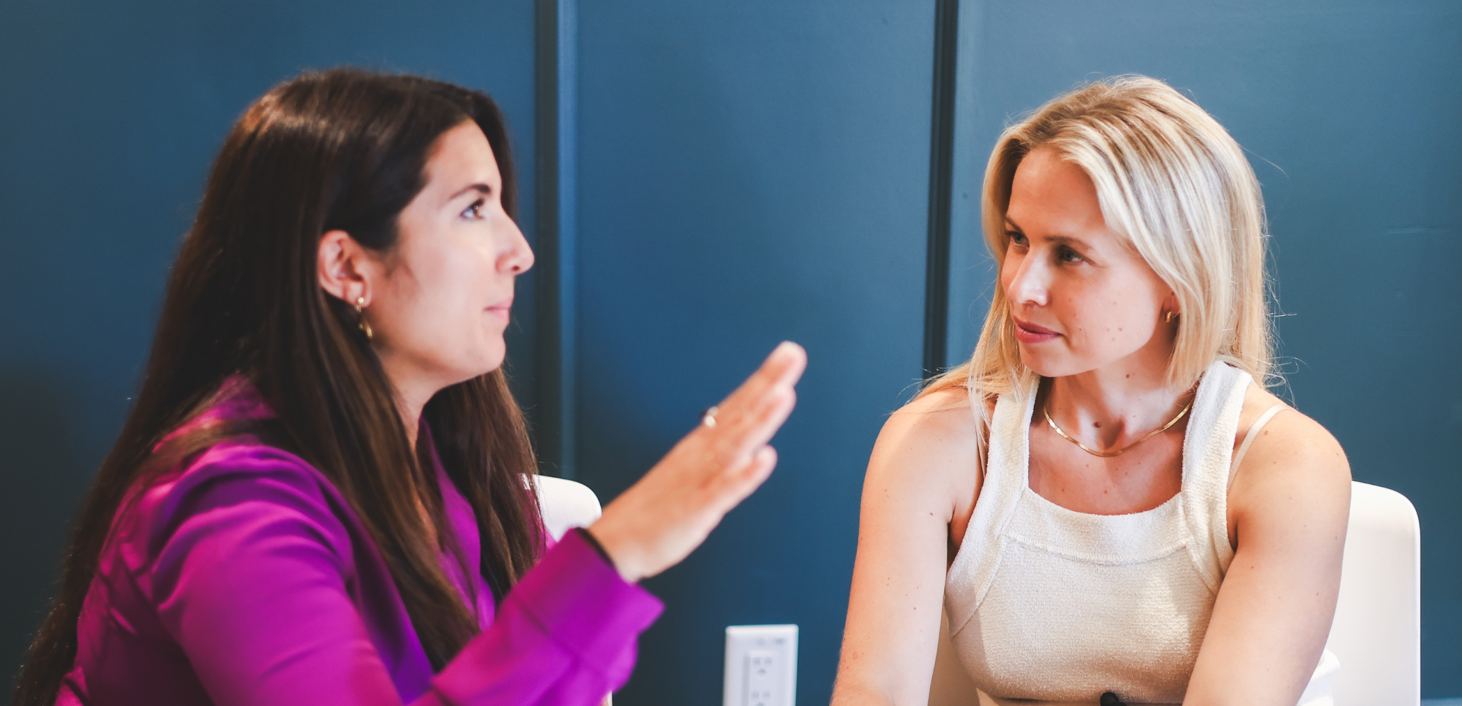 2 women having a conversation in a professional setting