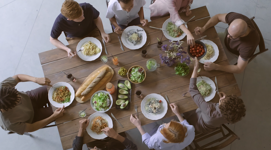 Overhead shot of eight people having a shared meal